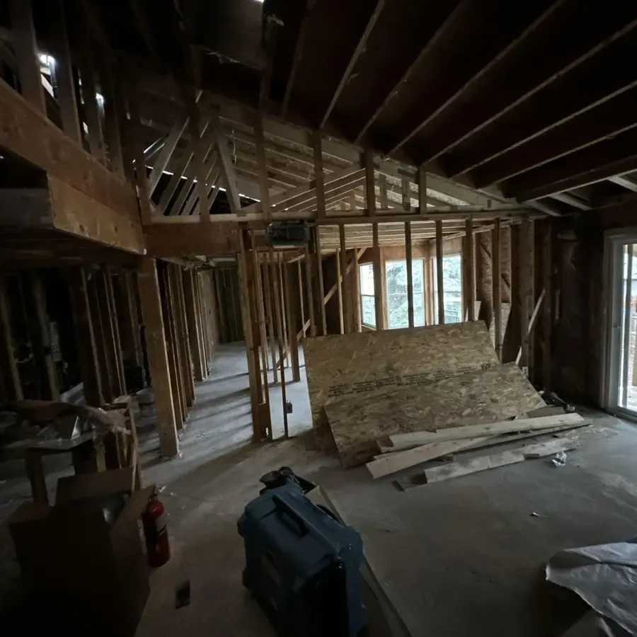 Room opened to the framing with a dehumidifier running on the subfloor