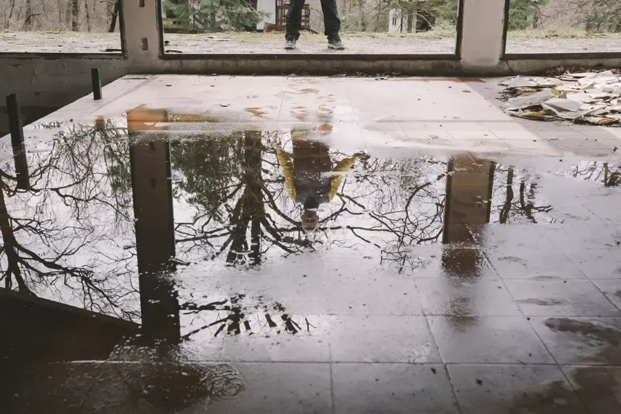 Floodwater standing across a tile floor inside a lower level after a storm